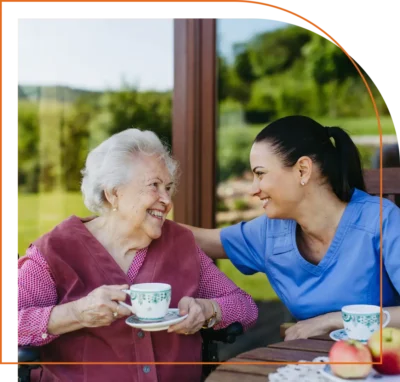 Caregiver sharing tea and laughter